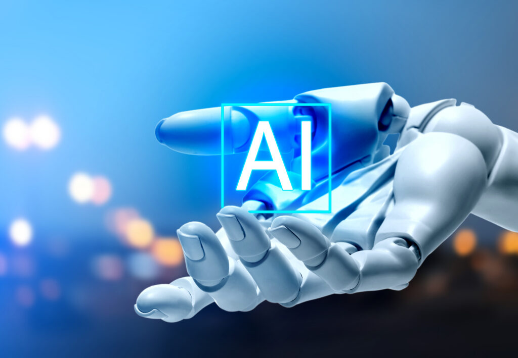 Robot hand holding virtual AI sign against blurred background. Artificial intelligence concept