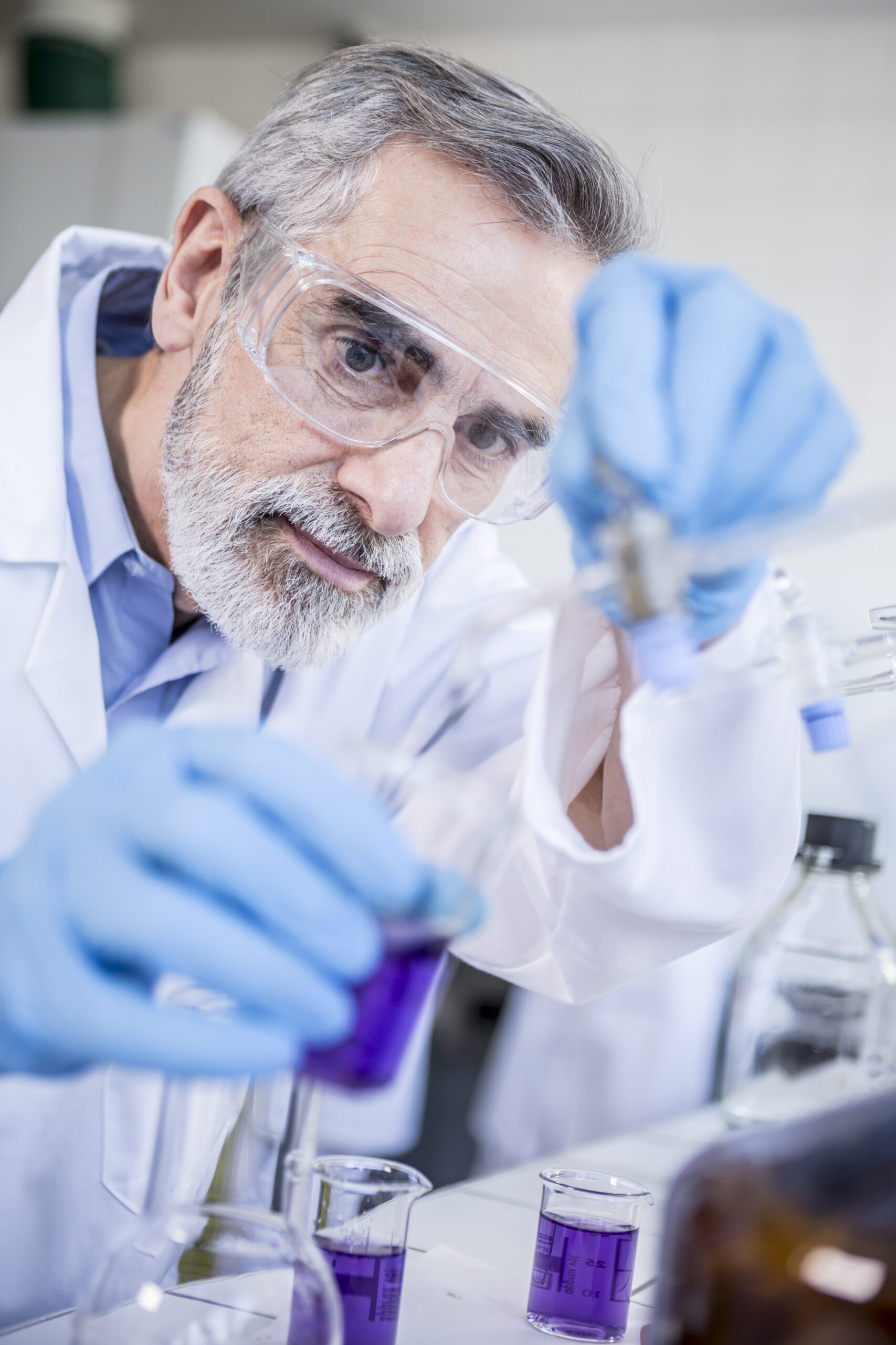 Scientist in lab working with liquid